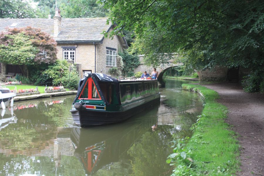 Narrowboat cruising on the Macclesfield Canal in Bollington