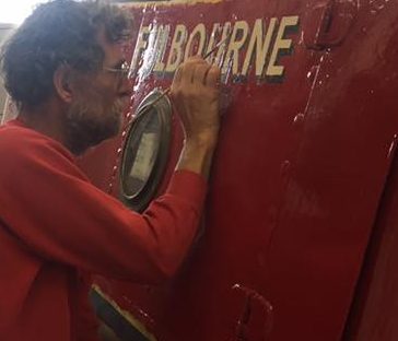 Touching up the painting and signwriting